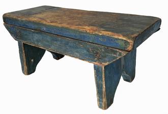 J314 Pennsylvania original blue painted wooden stool with decorative cut out feet and drop apron on each side. Drop apron sides feature beaded bottom edges and are mortised into legs. The legs are mortised through the top. Square head nail construction. Circa 1850 � 1860�s. Very sturdy stool with great wear from years of use. Measurements: 15� wide x 7 ¼� deep x 7� tall   