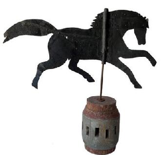 F289 Late 19th century Sheet iron running horse weathervane,  circa 1870 - 1890, mounted  on a painted early wooden  wagon hub base,  the Horse is showing wear from exposer to the weather, Measurements 30" h.