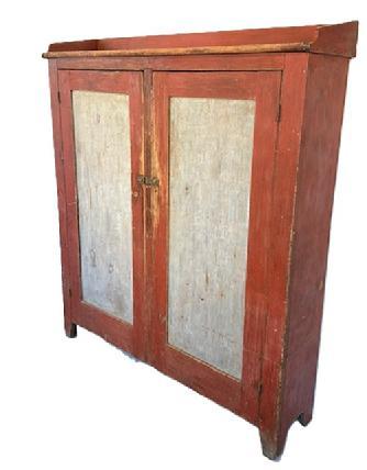 L298 Unusual early 19th century Lancaster County, Pennsylvania Storage Cupboard (Pantry) with original red and pewter gray painted surface featuring wide form with very unusual shallow 12-inch depth, an applied shaped gallery and cut out feet. This cupboard provides LOTS of storage opportunities within the clean, natural patina interior. The wood is pine, with square head nail construction. Both panel doors are fully mortised and pegged and surrounded by a deep beaded edge. Circa 1820s-1840s. Measurements: 55 ¼ wide x 13 ¾ deep (top) x 12 deep (case) x 63 ¼ tall (back) x 60 tall (front).