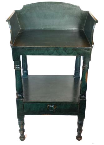 G653  Early 19th century Pennsylvania original green and black paint decorated pine bedside table with tall, dovetailed shaped backsplash that boasts canted and shaped rolled-edge sides. Shelf below with one tightly dovetailed drawer resting on nicely turned legs. Circa 1830s. Great workmanship and wonderful paint throughout! Measurements: 21 1/2� wide x15� deep x 37� tall  