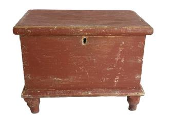  M148 Early 19th century miniature Blanket Chest retaining original dry red painted surface. Six-board pine with dovetailed case and applied moldings to top and bottom, resting on turned feet that are mortised through the bottom. Square head nail construction. Natural patina interior � with the name �Kay Floyd� written in several areas inside. Circa early 1800s.