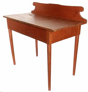 G866 NEW ENGLAND RED PAINTED LIFT LID WRITING DESK, circa 1820 featuring shaped backsplash, hinged lid concealing shallow well, and pencil post  legs with beveled-edge profile, period pencil inscriptions to underside of lid. Retains an original red-painted surface  First quarter 19th century. Measurements: 37 3/4" wide x 19 1/4" deep x 34 1/4" tall  (Apron to floor clearance is 21 ¾�) 