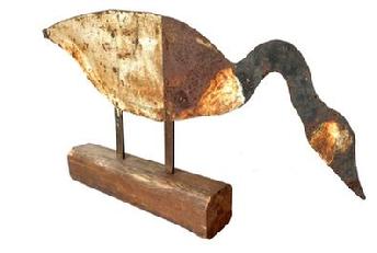 G868 American Folk Art cut out sheet iron Canada Goose confidence decoy. with two-part body raised on riveted supports. Original weathered, painted surface. Presented on a wooden base. Circa 1930.