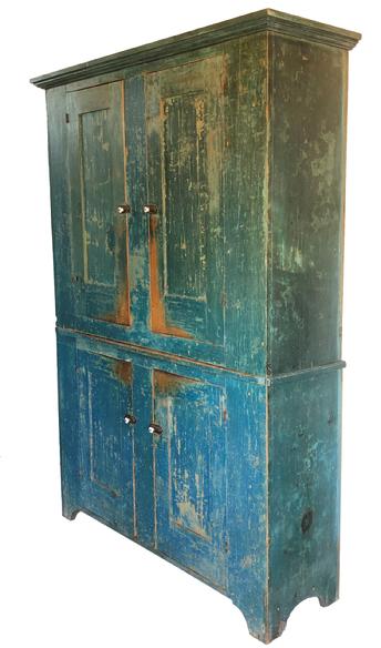 F13 A fine and unusual 19th century York County Pennsylvania flat wall storage cupboard retaining it's original blue paint, Four mortise and tenon joined and pegged paneled doors, opening to a shelved light mustard-painted interior, high shaped cut-out feet with an applied molded top. Circa 1820-1840  Measurements: 59" wide x 81 3/4" tall x 16" deep