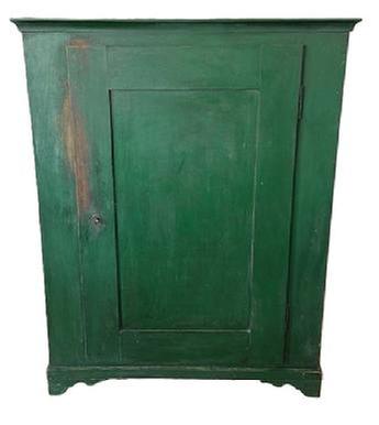 L535 19th century Lancaster County, Pennsylvania one door storage cupboard retaining old green painted surface over original red paint. Dovetailed case with applied molding surrounding the top and resting on dovetailed applied feet with nice cut out. Mortised door opens to reveal a clean, natural patina interior. The wood is poplar and pine. Circa 1850s. Measurements: 41 &frac14;� wide x 20� deep x 53 &frac14;� tall. 
