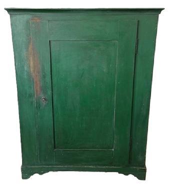 L535 19th century Lancaster County, Pennsylvania one door storage cupboard retaining old green painted surface over original red paint. Dovetailed case with applied molding surrounding the top and resting on dovetailed applied feet with nice cut out. Mortised door opens to reveal a clean, natural patina interior. The wood is poplar and pine. Circa 1850s. Measurements: 41 ¼ wide x 20 deep x 53 ¼ tall.