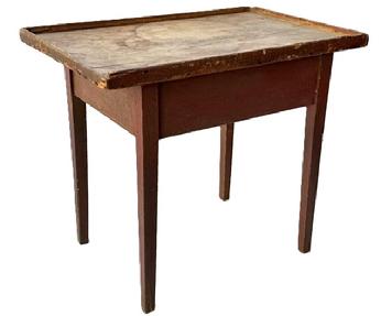 M265 Mid-19th century New England original red painted tray top table with one board, scrubbed top surrounded with applied gallery molding, resting on tapered legs. The apron is fully mortised and pegged into the legs. Square head nail construction. Measurements: 28 ¼ wide x 19 deep x 24 ½ tall. (Apron to floor measures 17 ¾).