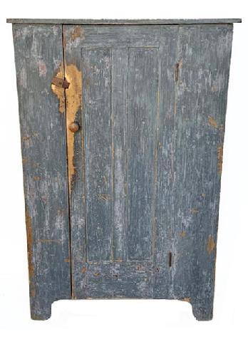 **SOLD** L291 Nice 19th century Pennsylvania one door cupboard bearing original old blue / gray over original red painted surface. Great wear. The paneled door opens to reveal a clean, natural patina interior with shelves for added storage options. The wood is pine, square head nail construction. Circa 1850s-1860s. Measurements: 39 ¼ wide x 18 ½ deep x 59 ¾ tall.