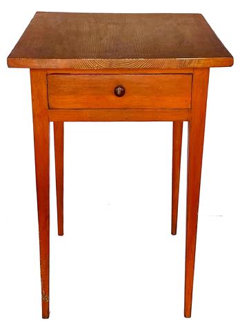 G915 18th century Maryland pumpkin painted Hepplewhite one drawer table boasting long, delicately tapered legs and one dovetailed drawer. Rosehead nail construction with the apron of the table being mortised into the legs and secured with wooden pegs. A distinctive pinwheel carved into each outer side of the drawer is visible when the drawer is removed. Great size and height!  Measurements: 21� wide x 25� deep x 30 ¼� tall. (24� from apron to floor)