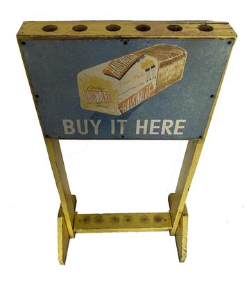 G451 Early 20th century Wooden Country Store Broom Holder  display rack in the original yellow paint,  with metal signs on either side advertising for Hauswalt's Bread Co. Baltimore Maryland.  Holds six brooms. double sided broom rack, normally displayed in country and hardware stores. It measures 37 1/2� tall, 18� wide  and 12� deep at the base /feet. 