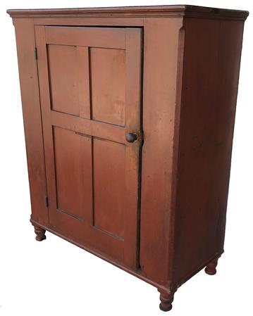 LD1  Early 19th century Lancaster County Milk Cupboard, with original dry red paint, dovetailed case top and bottom, single door with four nice champhered panels,mortied and pegged, with the original red paint inside of the door.. Lamb tongue corner, with the original mushroom turned knob, beautiful turned feet.circa 1800- 1820