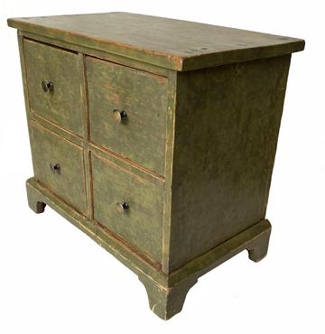 G774 19th century New England set of four drawers  with applied bracket base in a green sponge decorated paint. Dovetailed drawers will small brass knobs. The wood is pine with a one board top .  Measurements: 16 3/4" wide x 9 5/8" deep x 15" tall