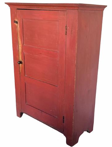 H980 19th century Pennsylvania one door storage cupboard with beautiful original red painted surface. Dovetailed case with applied molding around the top and nice cut out feet. Door is fully mortised and double pegged and features a beaded edge around all sides. Natural patina interior with several sturdy shelves for storage.  Measurements: Top is 41 ½� wide x 18 ¼� deep. Case is 38 ¾� wide x 16 ¾� deep. Overall height is 57 ¾� tall. 