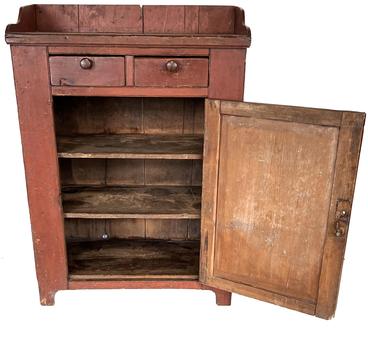 H234 Early 19th century Pennsylvania Jelly Cupboard, in the original red paint, dovetailed case  with two dovetailed drawers over  a single panel door, with a nice high cut out foot, and applied gallery, Nice and clean interior, original knobs. Measurements are: 51 ½� tall x 37� wide x 19 ½� deep
