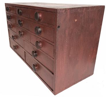  G913 Early 19th century Lancaster County Pennsylvania walnut red painted Apothecary with thirteen dovetailed drawers graduated drawers, from a Taylor Shop, one drawer is divided into compartments    the case of the apothecary is also dovetailed, the apothecary has a two board back held in place square head nails Measurements are: 30� long x 17� tall x 131/2� deep including knobs 