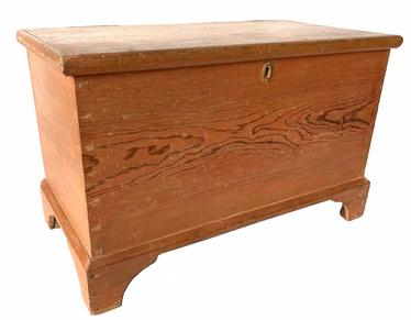 **SOLD** G785 Early 19th century Lancaster County, Pennsylvania diminutive blanket chest in original dry pumpkin paint. Six board dovetailed construction with applied dovetailed bracket base featuring nice cut outs, applied molding around three sides of the lid secured by small square head nails and small lidded glove till mortised inside. Measurements: 25� wide x 13� deep x 15 3/4� tall  