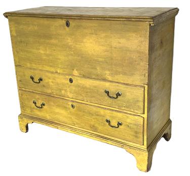 K317 Late 18th century New England chest over two drawers boasting vibrant yellow painted surface . The case and drawers are dovetailed. Tall, applied bracket base is secured with early T nails. Original strap hinges 