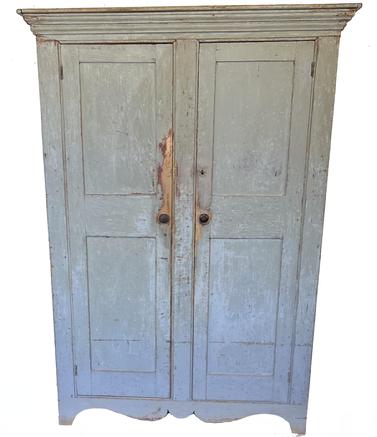 J348 Early 19th century New England two door flat wall Storage Cupboard, with wonderful dry old blue / gray paint. Clean interior, two panel doors, with five mortised shelves. Nice high cut out drop apron, great form. Circa 1840�s Measurements are: 49� wide x 18 ½� deep at top. Case is 44 5/8� wide x 16 ¾� deep. Overall height is 68 ¾� tall.