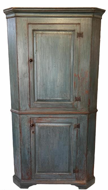 H57 Extremely rare Mid-18th century pine, Single Part, Blind Door Corner Cupboard. (Circa 1740-1760) Original Blue Paint, with two single raised panel doors held in place with original rare butterfly hinges, with rose head nails, the doors are full mortised with pin, the case of the Cupboard is resting on an applied bracket base, it still retains original waist molding, also a beautiful cove molding applied to the top.   Measurements are: 83-1/2"high. x 44"wide. x 24"deep. Condition: Good with wear.