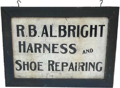 J204 Early Pennsylvania double-sided trade sign advertising �R. B. ALBRIGHT HARNESS AND SHOE REPAIRING� hand painted in black letters on a white painted background. Wear to the paint in the advertising area is indicative of age. The sign is painted on tin and is encased in a wooden frame. Both sides of the sign are in good condition. Unsigned. Overall measurements: 42� wide x 1 ¾� thick x 30 ¼� tall. The frame is 3 ½� wide. Tin sign area measures 35� wide x 23 ¼� tall. 