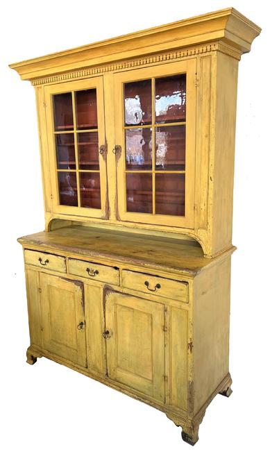 **SOLD** G430 American, Pennsylvania Lancaster County  Chippendale  A two-piece Dutch Cupboard in old yellow over the original red paint  first quarter 19th century., circa 180- 1810 ,the upper section having a stacked molded cornice with dental molding underneath over two six-glass pane doors with straight mullions, interior shelves consisting of plate rails, cup shelves and spoon slots, retaining he  original red paint , all above a pie shelf  over three dovetailed drawers with brass pulls, the lower section having  two panel doors with single shelf interior, all rising on applied  Chippendale  ogee bracket base; ht. 87� high , . 53� wide x. 22�  deep . 