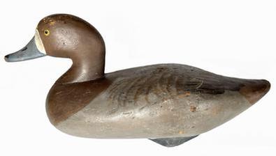 J247 Bluebill Hen decoy carved by Madison Mitchell Havre de Grace, MD (1901-1993) retaining its original painted surface.  Original weight and staple remain intact on bottom. Circa 1940's.