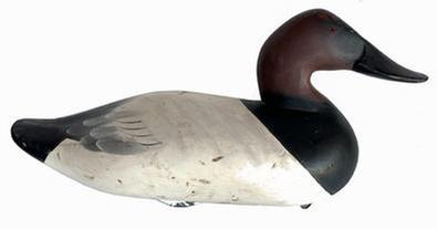 **SOLD**  J318 Canvasback Decoy carved by Charlie �Speed� Joiner (1921-2015) of Chestertown, MD. Original paint with wide bill, signed and dated 1965  retains original iron weight and ring on bottom.   Approximate measurements: 15 1/2" long x 6 3/4" wide x 8 1/4" tall