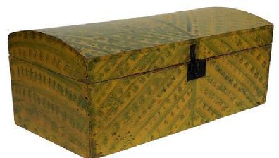E406 New England vibrantly painted dome lid box, 19th century, retaining its original yellow paint featuring broadly brushed stripes and dabbed green paint decoration. Dovetailed case and square nailed construction with wallpapered interior. Box retains its interior vapor barrier molding, original iron hardware, iron lock and hasp. Measurements: 10 ¼� h x 26� wide.