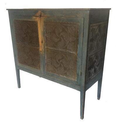 G875 GORGEOUS EARLY 19TH CENTURY SHENANDOAH VALLEY OF VIRGINIA FOOD SAFE wide rectangular top above two doors concealing two shelves with a lower divider, the Food Safe is raised on square-legs. Each door and end set with two oversized joined tins hand punched with a central fylfot surrounded by fans.  original blue-painted surface. Found in eastern Rockingham Co., VA. Second quarter 19th century. Measurements are 53 ½ � high x 53 wide x 23 deep 