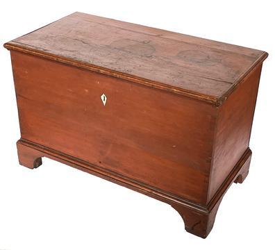 J128 19th Century Pennsylvania original red painted blanket chest with dovetailed case, applied dovetailed bracket base with cut out feet and applied molded edges around the lid. Nice hand inlaid escutcheon around the keyhole appears to be made of either bone or ivory. Clean, natural patina interior boasting original strap hinges, a molded edge lidded till and original crab lock.