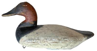 *SOLD* F245 Canvasback Duck Decoy by James T. Holly (1855 to 1935) Havre de Grace, Maryland. This decoy is from the 1st quarter 20th century, and has been professionally cleaned down to its original paint. Circa 1915 � 1920. Original weight and ring still in tact on bottom. Evidence of decoy being �shot� over is present in various locations of the head and body.