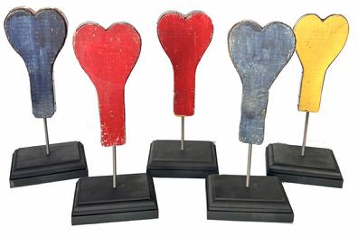 Z300 Carnival Heart Ring Toss  painted in red, yellow, and blue, these doweled hearts fit into black painted base  and were used for a ring toss game in a mid-century carnival. Some of the hearts were reinforced with strips of sheet metal along their sides, such as these , beautiful color.