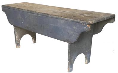 19th century Pennsylvania sturdy wooden bench in old dry gray paint over original gray paint. Bench features tall half-moon cut out feet and wonderful dropped apron sides that hang down 7 1/2�.   All square head nail construction. Pine wood. Circa 1860s. Measurements: 48� wide x 13 1/4� deep x 18 3/4� tall  