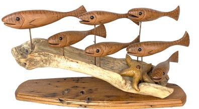 G677   School of Fish Sculpture carved by George W. Combs (1943-2001) of Trappe, MD - Featuring a school of seven (7) hand carved and painted Fish and a carved Starfish on a piece of driftwood.  The Fish decoys each have tack eyes and distinctly carved mouths. 