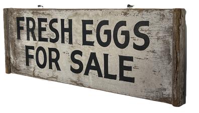 **SOLD** L20 19th century Pennsylvania trade sign with "Fresh Eggs" hand painted in black letters on a white painted background. The sign is double sided with an applied molded edge on each end. The wood is pine with square head nail construction.  Measurements: 25 ½ wide x 9 ¼ tall x ¾ thick x 1 ¼ thick on each end.  