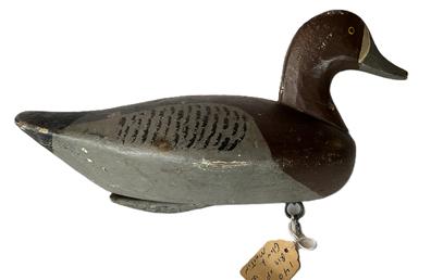 K1745 Branded Bluebill Duck decoy carved by John Glenn (1876-1954) of Rock Hall, Maryland. Branded G L M on bottom (this was the rig brand of Glen L. Martin). Original weight, staple and ring intact on bottom. John Glenn was both a waterman and farmer for most of his life. He started carving in 1916 and continued through the early 1930's.  