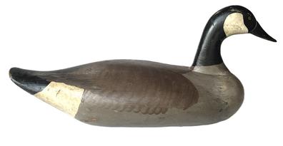 K1512 Canadian Goose decoy carved by Madison Mitchell, Havre de Grace, MD (1901-1993) retaining its original painted surface. Original staple/ring intact on bottom  weight is missing. Damage to tip of bill. Full body sized goose decoy measuring approximately 24" long x 11 tall x 10 wide. 