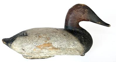 J216 Very early Canvasback Drake Decoy by Capt. John "Daddy" Holly (1818-1892) of Havre de Grace, Maryland. Second coat of working paint with areas of original paint showing, along with evidence of being shot over. Original iron keel weight, ring and staple intact on bottom. 
