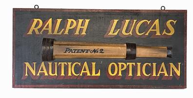 J321 Hand painted New England Trade Sign advertising �Ralph Lucas Nautical Optician� with applied wooden replica of a �No. 2� telescope. Measurements: 23 3/8� wide x 10 ¾� tall x 5/8� thick. (The applied wooden replica telescope measures 1 1/8� thick x 17 ¼� long x 3 1/8� tall.)