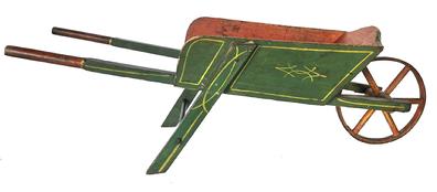 J48  Late 19th century Child's wheelbarrow in original green and bittersweet painted surface with yellow paint decoration. Wheel is constructed of an iron band over wooden spokes and turns freely. Great size for display! Nice wear. Circa 1900. Measurements: 35 ½� long x 11 ½� wide x 11� tall
