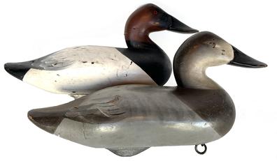 K3 Pair Charlie Joiner "wide billed" Canvasback Decoys  signed and dated: Charlie Joiner Chestertown, MD 1965 on bottom of each decoy. Both decoys bear the original painted surface that shows true gunning wear, and each retains their original weight, staple and ring intact on bottom.