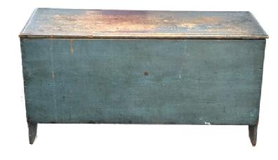 M1122 Early 19th century New England blanket chest retaining old blue painted surface. Six board, square head nailed construction with boot jack cut out feet on each end. The lid features a chamfered edge and mortised stretchers beneath the lid are what have kept it from warping / twisting over the years. Clean, natural patina interior with till. The wood is chestnut. Circa 1820s. Measurements: 46 &frac34;� wide x 18� deep x 24� tall. 