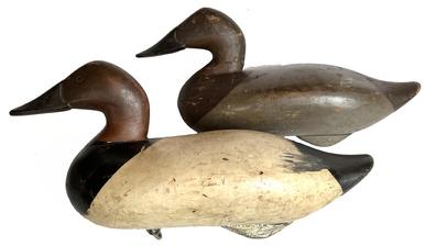 I6 Early 1940's Madison Mitchell pair of rig mate Canvasback decoys with "O" brand on bottoms and rig -stamped "H.G. Staples". Original paint. Original staple, ring, and weight remains intact on bottom of each decoy. It is very hard to find a matching pair this early!  
