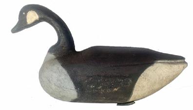 H515 Full sized Canadian Goose Decoy with carved feathers and distinct shelf neck. Original staple and two, very primitive crossed weights are intact on bottom. Found on the Eastern Shore of Maryland. Carver unknown.  Measurements: 21 5/8� long x 6 ¾� wide x 11 ½� tall