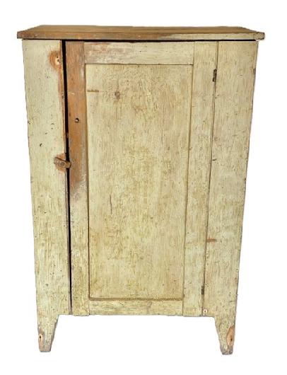 K1604 Early 19th century Lancaster County, Pennsylvania one door cupboard bearing original painted surface resting on tall cut out feet. A beaded edge runs along each side of the paneled door that opens to reveal shelves for storage and a clean, natural patina interior. Square head nail construction. The wood is pine. Circa 1820s. Measurements:  31 ¼ wide x 16 ¾ deep x 48 ¾ tall.     