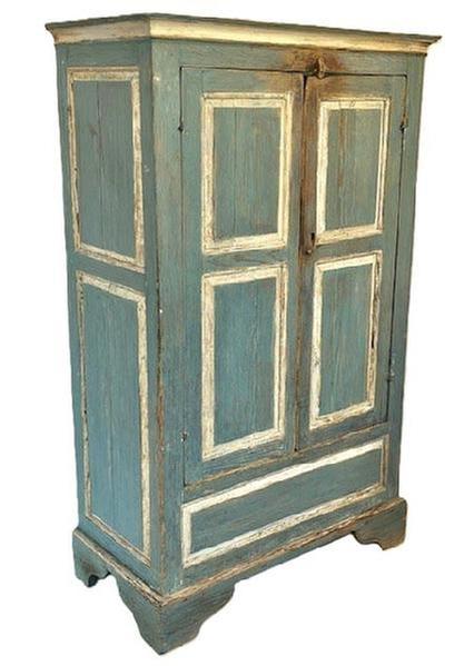 GM1 Exceptional 18th century Eastern Shore, Virginia original blue and white painted raised panel Clothes / Linen Press adorned with two raised panel doors, each with two panels, over one long panel below the doors. Each end is adorned with two large, raised panels. Cupboard rests on an applied bracket base with nice cut out feet. Top is surrounded by crown molding. All of the rails and tenons are mortised and secured with wooden pegs.  The doors are attached with their original snipe hinges. A wooden turn knob at the top secures the doors closed. The extensive wear around this knob is evidence of many years of use. The wood is yellow pine. Rosehead nail and wooden pegged construction. Circa 1740s-1760s. Measurements: 39 &frac12;� wide x 20 &frac34;� deep x 65� tall. (Reference Book: Eastern Shore, Virginia Raised-Panel Furniture 1730-1830 by The Chrysler Museum Norfolk, Virginia � pages 32-39.)  