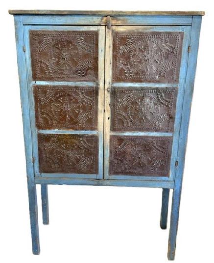 M1116   Early 19th century, Pennsylvania,( Circ 1820)  original blue painted, 12 tin Pie Safe With the original hand punched tins in the star pattern, The Pie safe boasts beautiful pith sawed three board back, and rests on tall legs.  It has a Clean, natural patina interior, with three fixed shelves. Measurements are 16" deep x 38 &frac14;� wide x 58 &frac34;� tall (the height from the floor to the case is 20 &frac12;�).