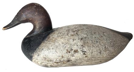 G687 Canvasback decoy carved by John Graham of Charlestown, MD cleaned to the original paint. Branded '3' on bottom. Retains original ring and weight on bottom.  Working condition with visible evidence of being shot over.
