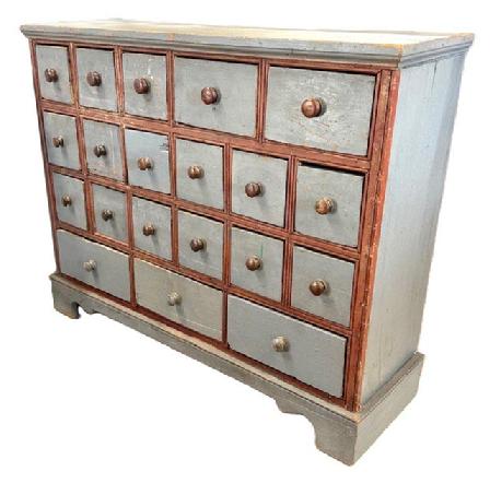 **SOLD** M88 Late 19th century Western Maryland 20 drawer Apothecary retaining original pewter gray paint with original red painted double beaded edge molding surrounding the drawers. Unusual drawer configuration with an applied bracket base and applied molding along the top. Square head nail and small wire nail construction. The wood is pine. Measurements: 44 ¾ wide x 13 ¾ deep x 35 ¾ tall.