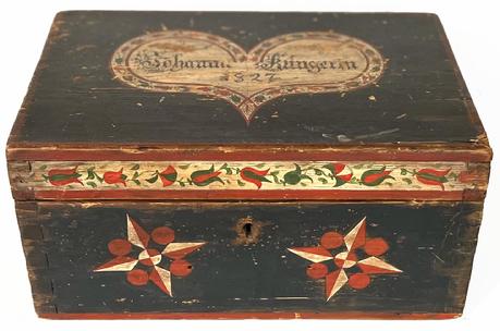 H1030 Exceptional early 19th century Pennsylvania Folk Art heart-decorated identified and dated storage box retaining its original surface featuring beautiful hand painted decorations. Identified and dated 1827 on the top of lid. This fantastic piece was published in The Nations Fine Antiques Newspaper October 1984 and Folk Hearts A Celebration of the Heart Motif in American Folk Art from 1660- 1880 Cynthia V.A. Schaffner and Susan Klein as seen in the documents that are included with this item. Dovetailed construction. Measurements: 12 wide x 8 deep x 6 tall